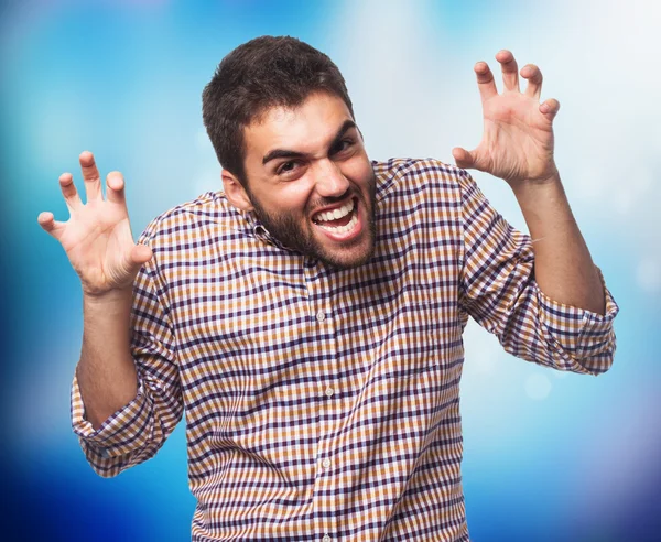 Young man doing aggressive gesture — Stock Photo, Image