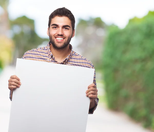 Joven sosteniendo pancarta — Foto de Stock