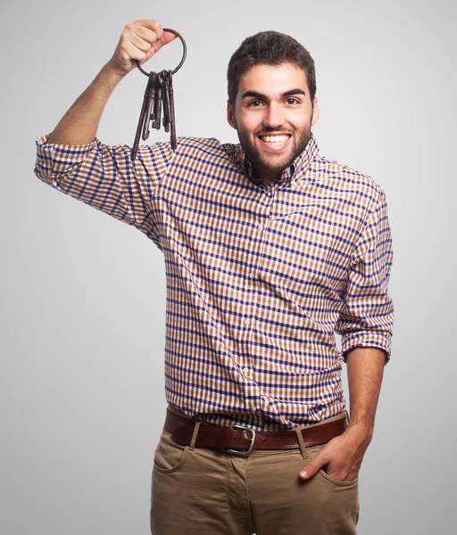 Young man holding old keys — Stock Photo, Image