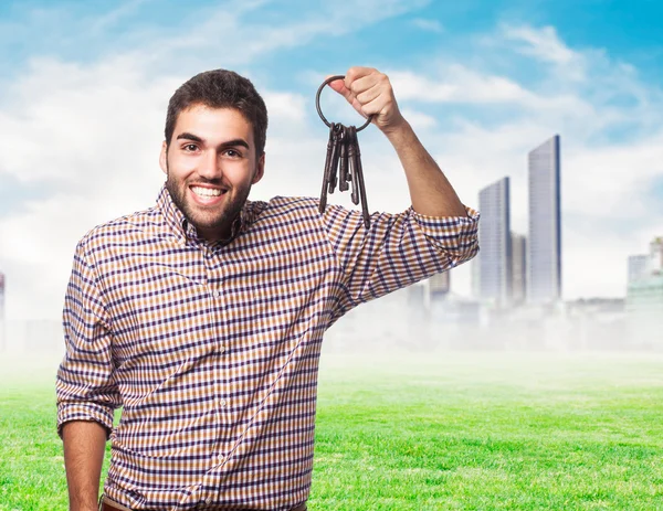 Young man holding old keys — Stock Photo, Image