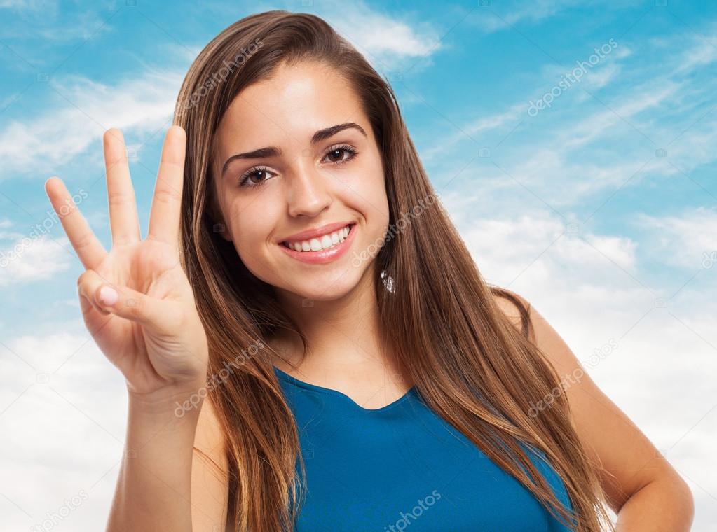 Pretty young woman counting with fingers