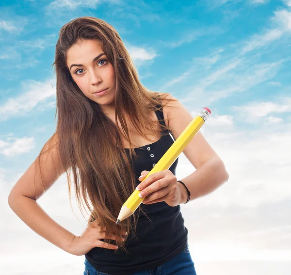 Student holding a big pencil — Stock Photo, Image