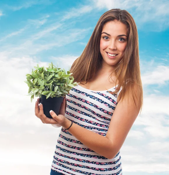 Girl holding a plant — Stock Photo, Image