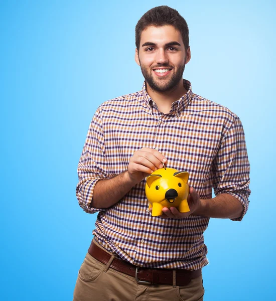 Man holding a piggy bank — Stock Photo, Image