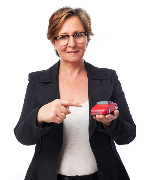 Woman holding car — Stock Photo, Image