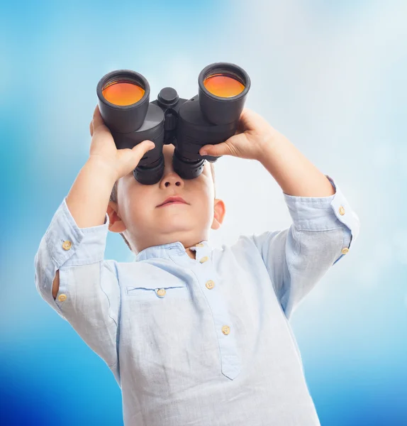 Boy looking through the binoculars — Stock Photo, Image