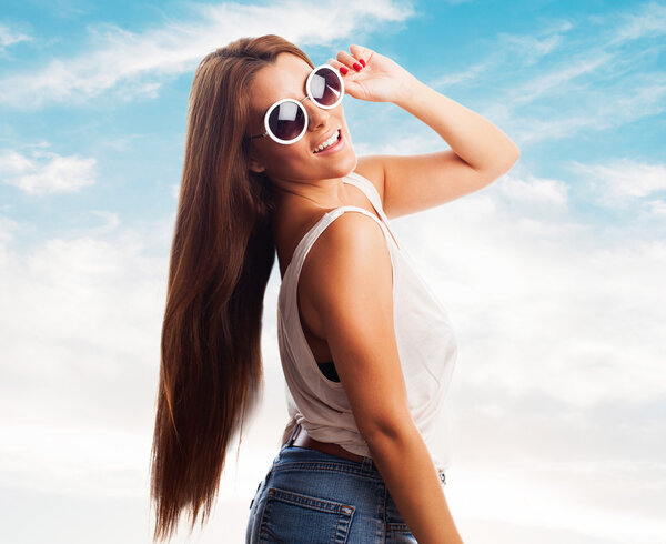 Portrait of a beautiful young woman posing with sunglasses