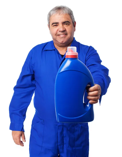 Mechanic holding an oil bottle — Stock Photo, Image