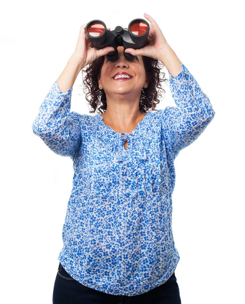 Woman looking through the binoculars — Stock Photo, Image