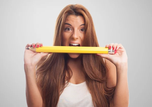 Donna mordere una matita grande — Foto Stock