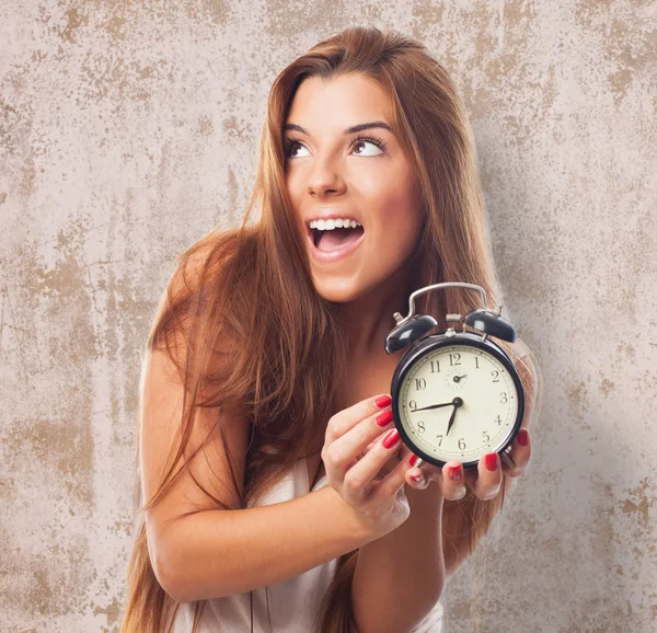 Pretty woman holding a clock — Stock Photo, Image