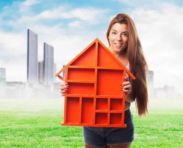 Woman holding a house design — Stock Photo, Image