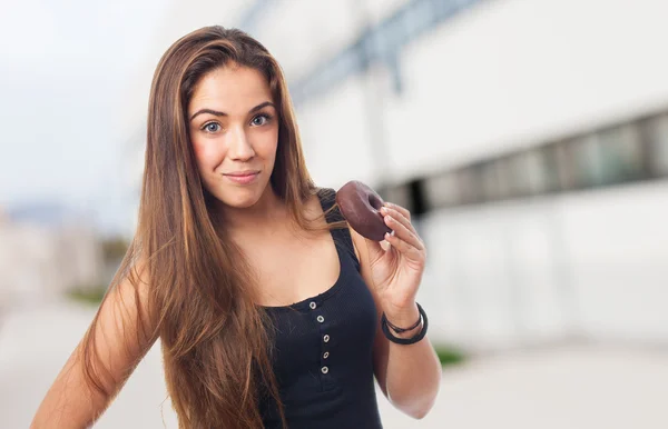 Woman holding a donut — Stock Photo, Image