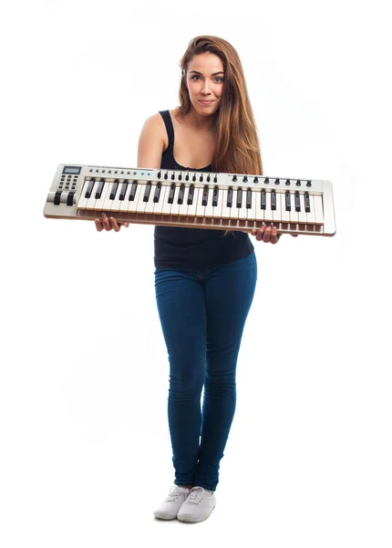 Woman holding an electronic piano — Stock Photo, Image