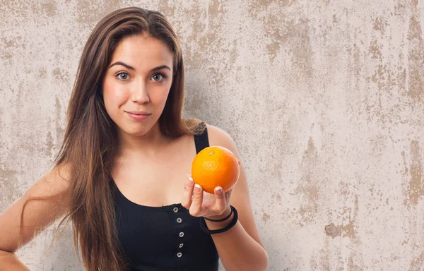 Girl holding an orange — Stock Photo, Image