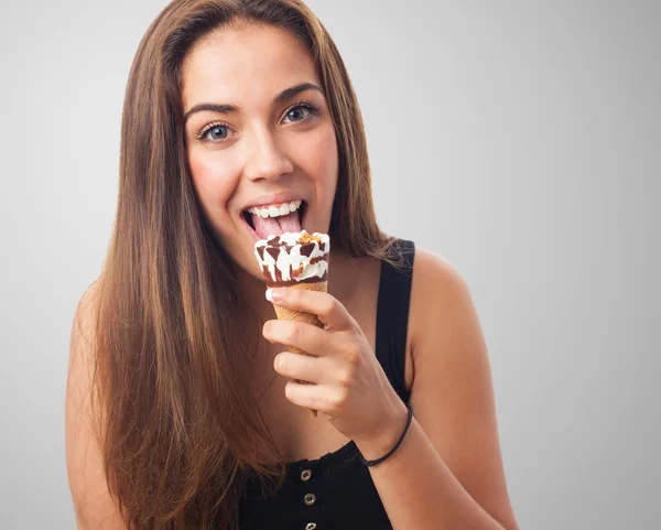 Young woman licking an ice cream — Stock Photo, Image