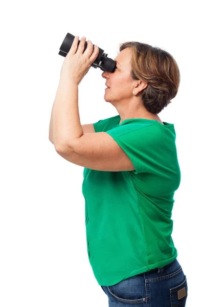 Zralá žena dívá dalekohledem — Stock fotografie