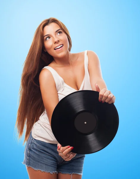 Mulher segurando um vinil — Fotografia de Stock