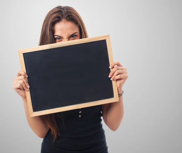 Meisje achter van een schoolbord — Stockfoto