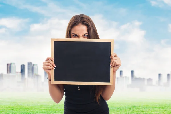 Girl behind of a chalkboard — Stock Photo, Image