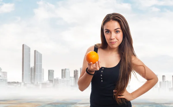 Girl holding an orange — Stock Photo, Image