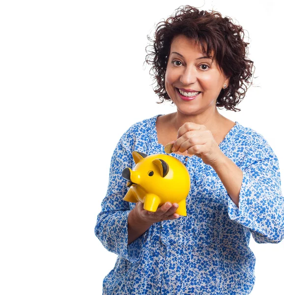 Woman putting a coin on a moneybox — Stock Photo, Image