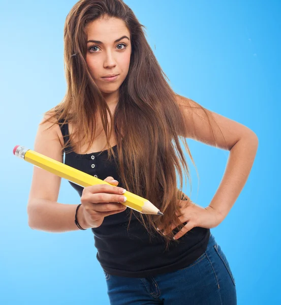 Student holding a big pencil — Stock Photo, Image