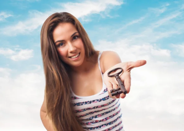 Girl holding a vintage key — Stock Photo, Image