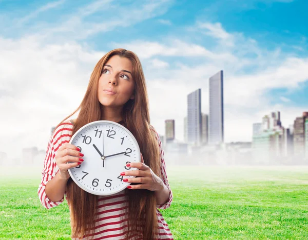 Woman holding a clock — Stock Photo, Image