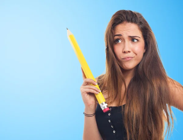 Student holding a pencil and thinking about — Stock Photo, Image