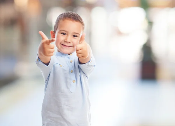 Little boy doing the victory gesture — Stock Photo, Image