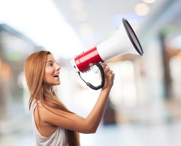 Woman shouting through megaphone — Stock Photo, Image