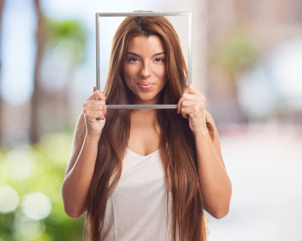 Young woman holding a frame — Stock Photo, Image