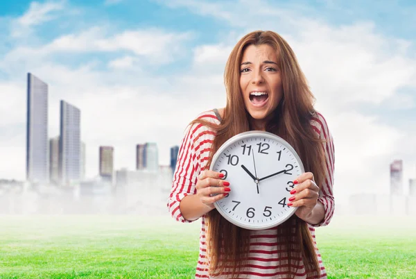 Woman holding a clock — Stock Photo, Image