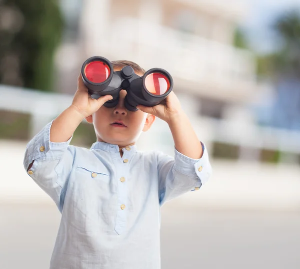 Boy looking through the binoculars — Stock Photo, Image