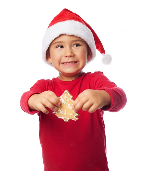 Garçon tenant un biscuit au gingembre — Photo