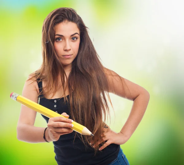 Student holding a big pencil — Stock Photo, Image