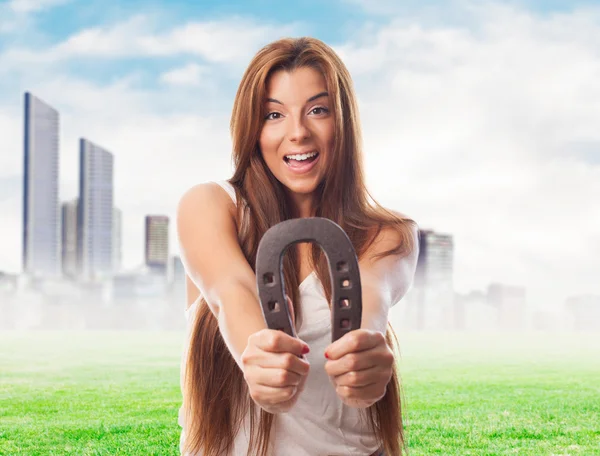 Woman holding a horseshoe — Stock Photo, Image