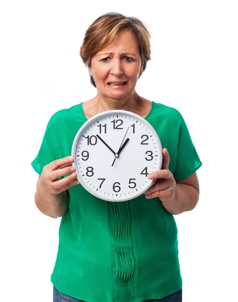 Mature woman holding a clock — Stock Photo, Image