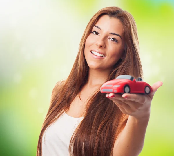 Woman holding a red car toy — Stock Photo, Image