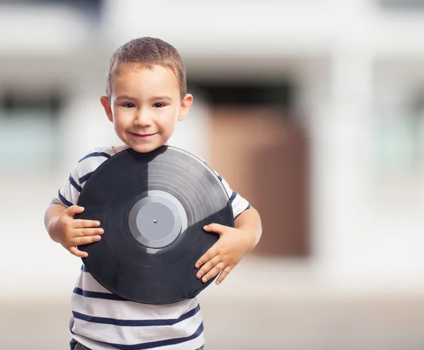 Boy holding a vinyl record — Stock Photo, Image