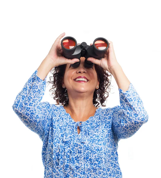 Woman looking through the binoculars — Stock Photo, Image