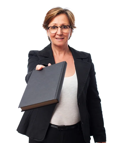Woman giving a book — Stock Photo, Image