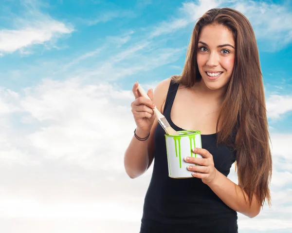 Portrait of young woman holding a brush and a paint can — Stock Photo, Image