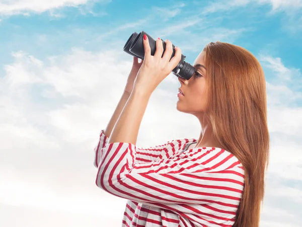 Woman looking throught a binoculars — Stock Photo, Image