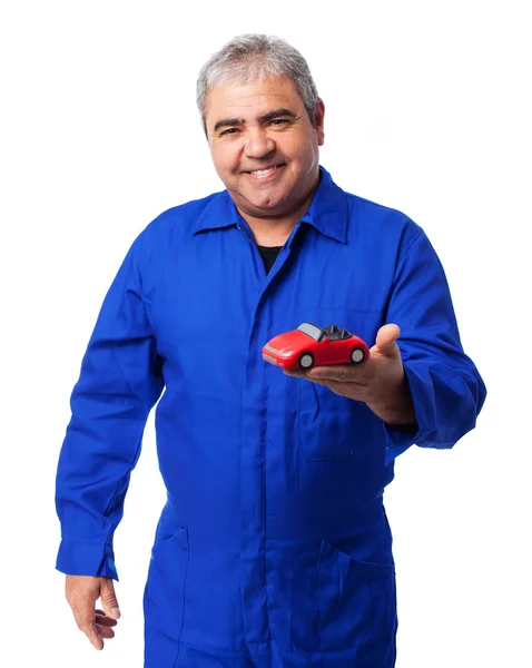 Mechanic holding car toy — Stock Photo, Image