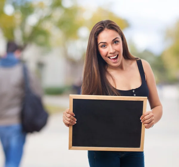 Student holding a chalkboard — Stock Photo, Image