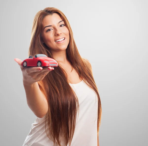 Woman holding a red car toy — Stock Photo, Image