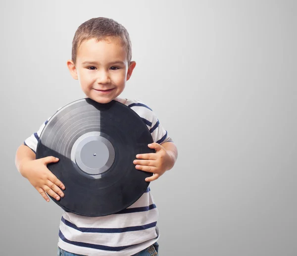 Boy holding a vinyl record — Stock Photo, Image