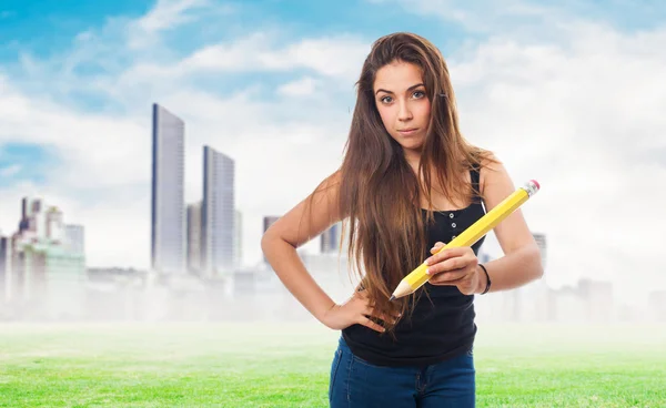 Student holding a big pencil — Stock Photo, Image